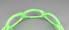 Green satin wrapped fabric 1 3/8″ wide headband oval chain link cut out pattern