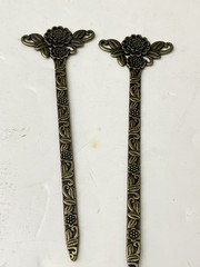 vintage-style set of 2 bronze-tone hair sticks featuring a floral design.