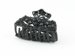 Black metal hair claw clip with black stones on a tiny floral pattern
