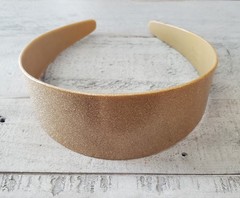 Stylish gold glitter headband. Perfect for adding sparkle to any outfit.