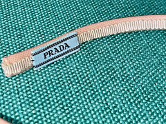 Prada saffiano leather headband with a floral embellishment